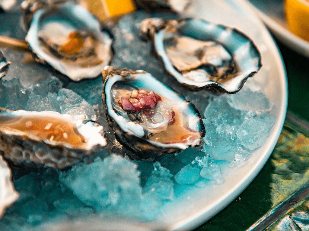 Oysters with mignonette on a platter with ice